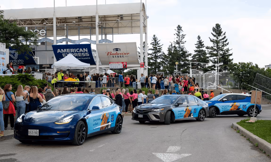 Walmart campaign vehicles arriving beside the crowd at Budweiser Stage