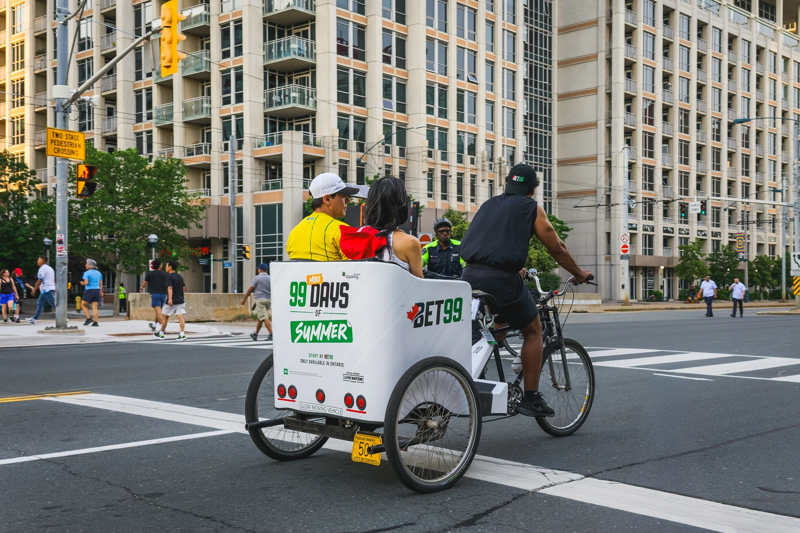 BET99 branded pedicab carrying passengers through the city