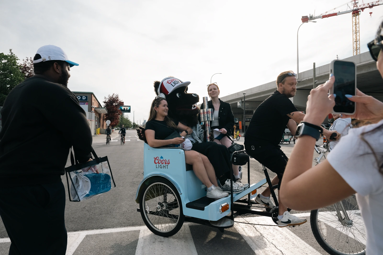 Coors Light branded pedicab with guests posing for a photo